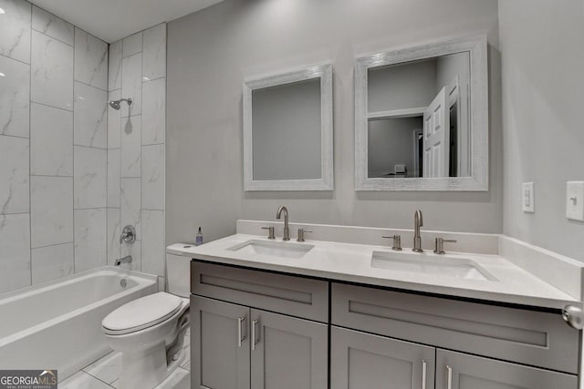 full bathroom with double vanity, shower / bathing tub combination, a sink, and toilet
