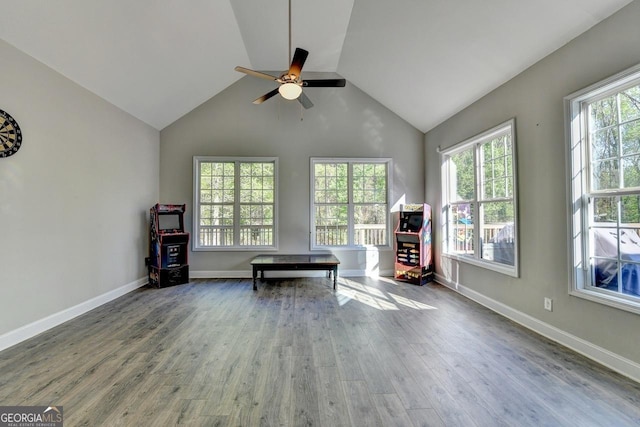 sitting room with baseboards, vaulted ceiling, a ceiling fan, and wood finished floors