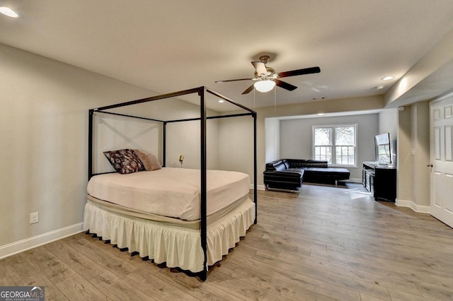 bedroom with light wood-type flooring, ceiling fan, baseboards, and recessed lighting