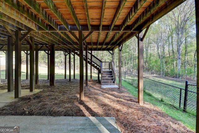 view of yard with fence and stairway
