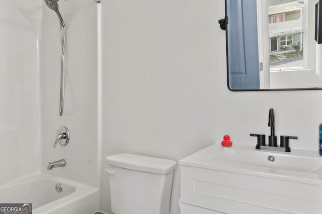 bathroom with toilet, vanity, and  shower combination