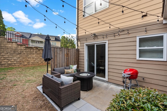 view of patio / terrace featuring a fire pit and fence