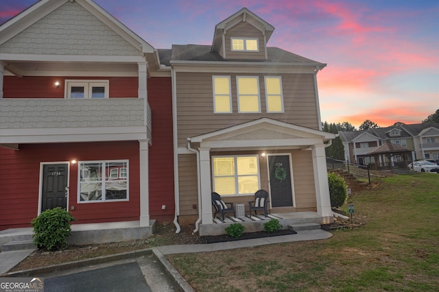 multi unit property with a porch and a yard