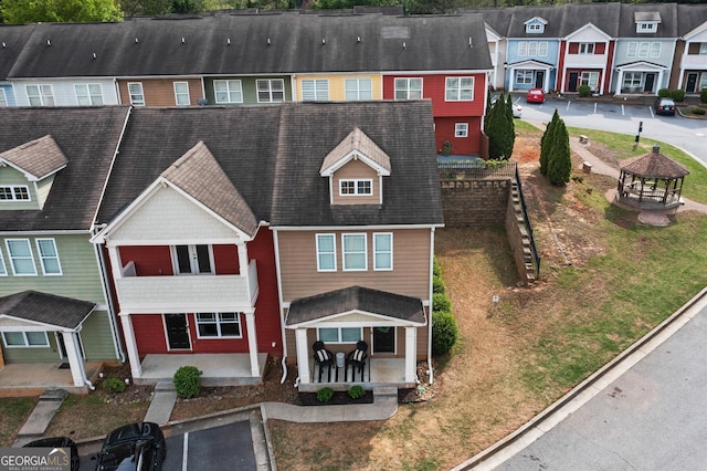 view of front of house with a gazebo, a shingled roof, and a residential view