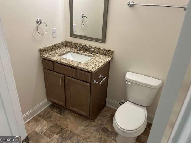 202 Gamel Rd, Dallas, GA 30157 - bathroom featuring toilet, stone finish floor, vanity, and baseboards