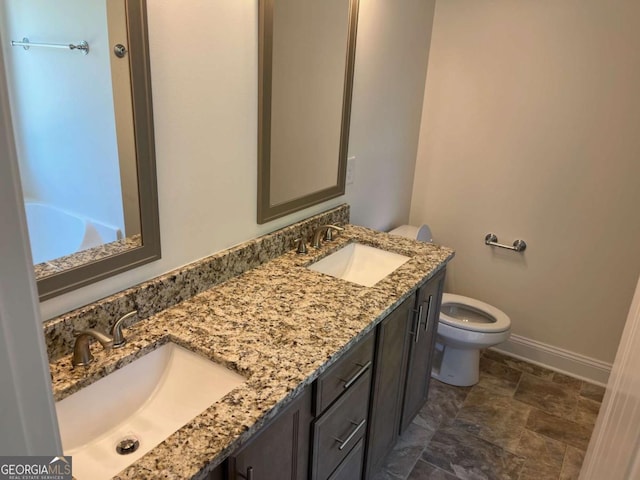 202 Gamel Rd, Dallas, GA 30157 - bathroom with toilet, double vanity, a sink, and baseboards