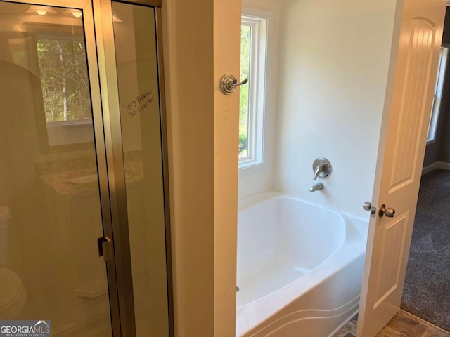 202 Gamel Rd, Dallas, GA 30157 - bathroom featuring toilet, a bath, and a shower stall