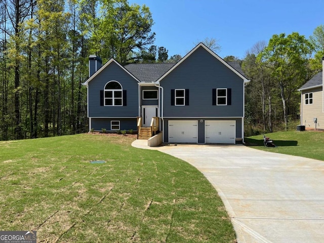 202 Gamel Rd, Dallas, GA 30157 - bi-level home featuring a garage, driveway, a chimney, and a front lawn