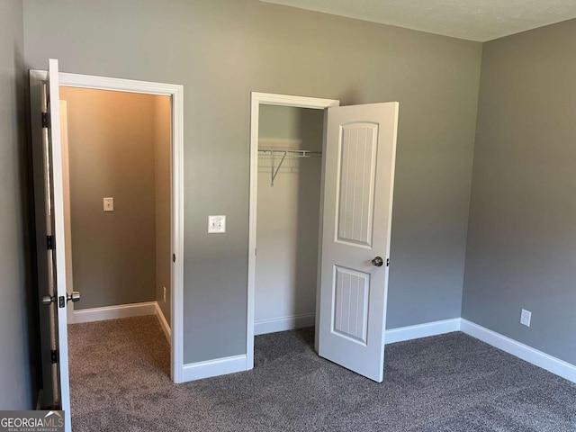 202 Gamel Rd, Dallas, GA 30157 - unfurnished bedroom with dark carpet, a closet, and baseboards