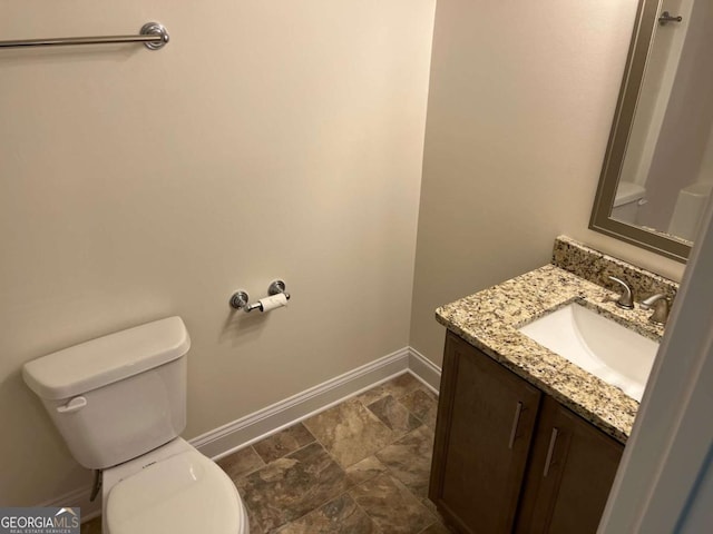 202 Gamel Rd, Dallas, GA 30157 - bathroom featuring toilet, vanity, baseboards, and stone finish flooring