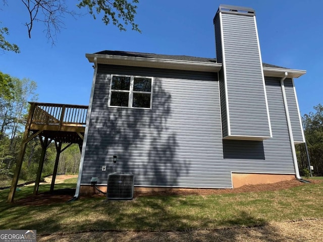 202 Gamel Rd, Dallas, GA 30157 - view of side of home featuring a yard, a wooden deck, cooling unit, and a chimney