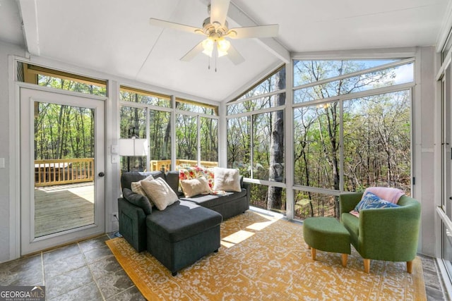 sunroom / solarium with a wealth of natural light, beamed ceiling, and ceiling fan