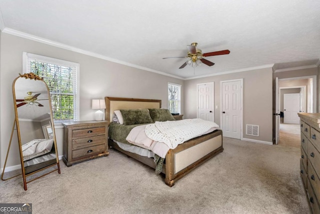 bedroom featuring crown molding, light colored carpet, baseboards, and multiple windows