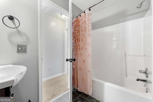 full bathroom featuring shower / bath combo, tile patterned floors, and a textured ceiling