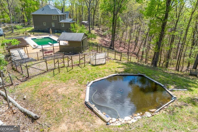 view of yard with fence and a fenced in pool