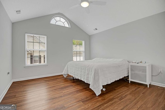 bedroom featuring a ceiling fan, visible vents, wood finished floors, lofted ceiling, and baseboards