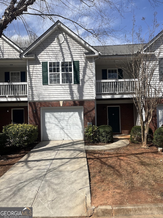 2127 Manhattan Pkwy, Decatur, GA 30035 - view of front of house with a balcony, an attached garage, concrete driveway, and brick siding