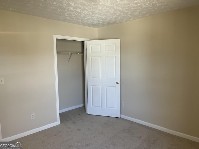 2127 Manhattan Pkwy, Decatur, GA 30035 - unfurnished bedroom featuring carpet flooring, baseboards, and a closet