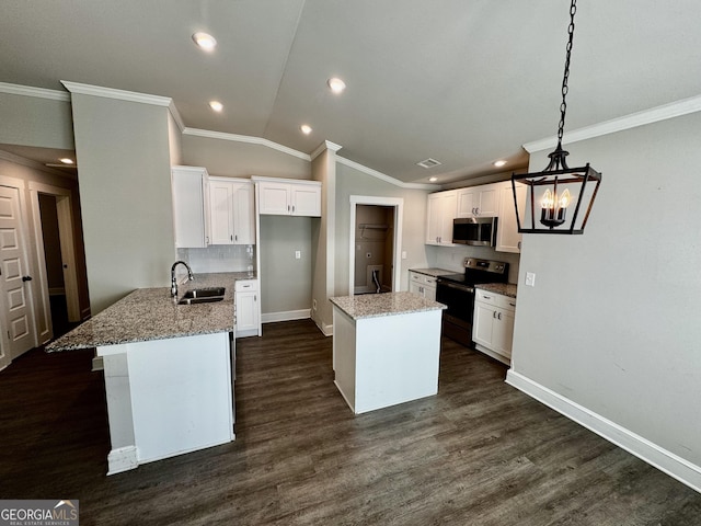 1037 E Doyle St, Toccoa, GA 30577 - kitchen with appliances with stainless steel finishes, white cabinets, a peninsula, crown molding, and vaulted ceiling