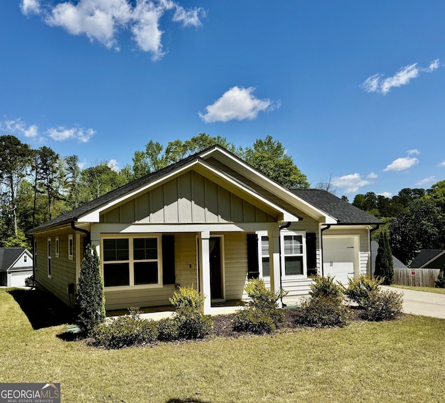 1037 E Doyle St, Toccoa, GA 30577 - view of front of property with an attached garage, board and batten siding, a front lawn, covered porch, and driveway