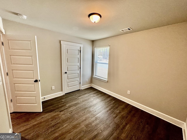 1037 E Doyle St, Toccoa, GA 30577 - unfurnished bedroom featuring dark wood-style flooring and a closet