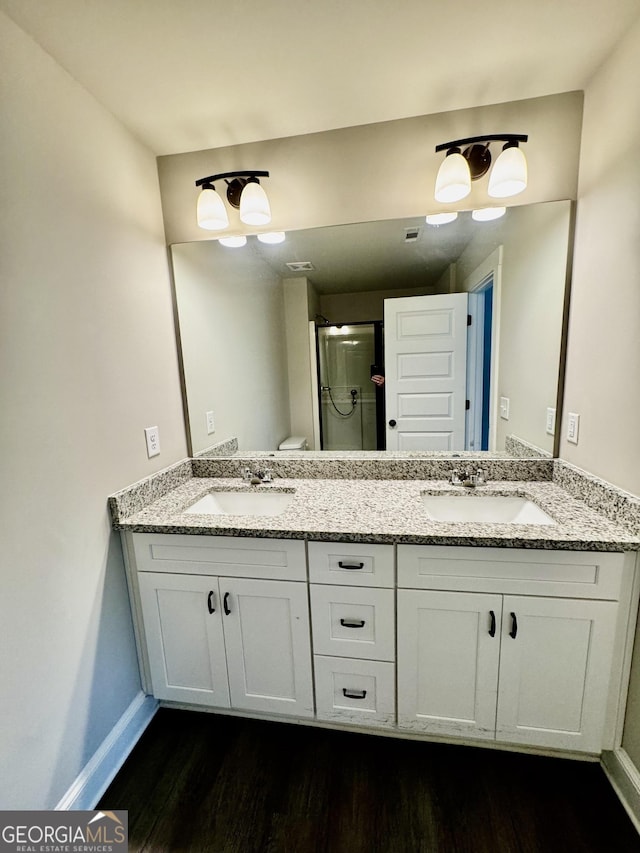 1037 E Doyle St, Toccoa, GA 30577 - full bath featuring wood finished floors, double vanity, and a shower stall