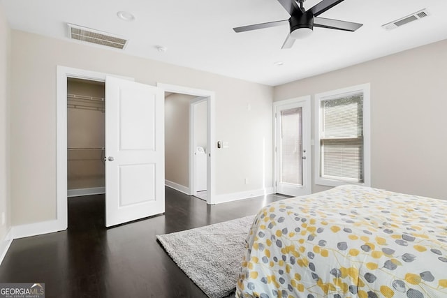 bedroom with a closet, visible vents, baseboards, and dark wood-style floors