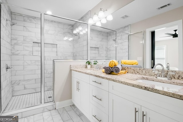 full bathroom featuring a sink, marble finish floor, and a stall shower