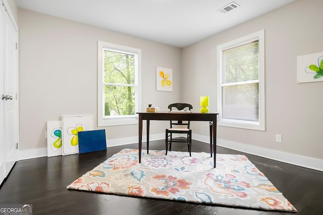 home office featuring wood finished floors, baseboards, and visible vents