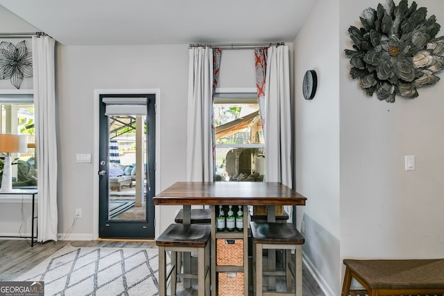dining room featuring baseboards and wood finished floors