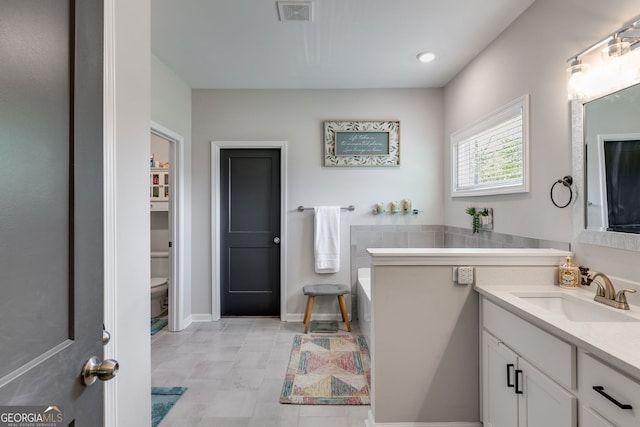 full bath featuring a bath, visible vents, toilet, and vanity