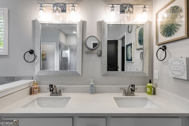 bathroom with a sink, double vanity, and a stall shower