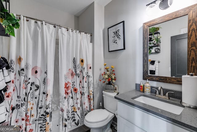 bathroom with a shower with curtain, vanity, and toilet