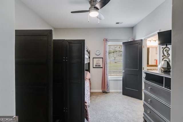 bedroom with light carpet, baseboards, visible vents, and a ceiling fan