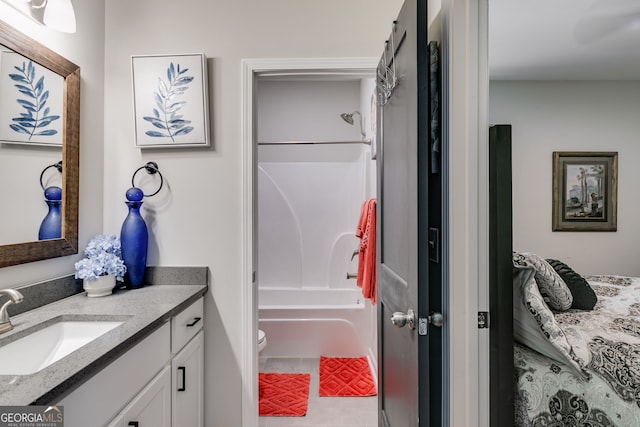 bathroom with toilet, vanity, and shower / bathing tub combination