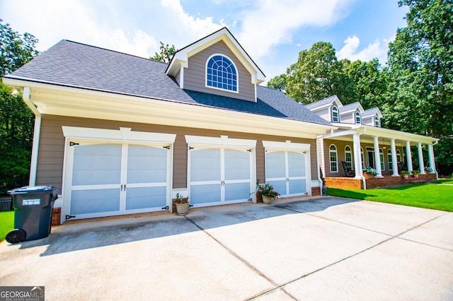 4149 Yancey Rd, Douglasville, GA 30135 - view of front of home with a porch, roof with shingles, a front lawn, an attached garage, and concrete driveway