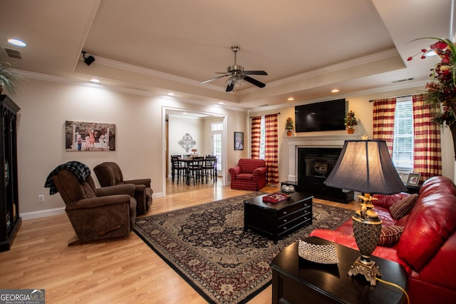 4149 Yancey Rd, Douglasville, GA 30135 - living area featuring a tray ceiling, ceiling fan, visible vents, and plenty of natural light