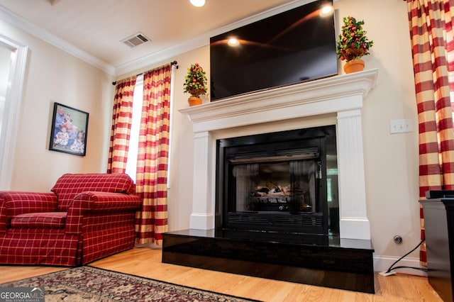 4149 Yancey Rd, Douglasville, GA 30135 - interior space with visible vents, baseboards, a fireplace with raised hearth, ornamental molding, and wood finished floors
