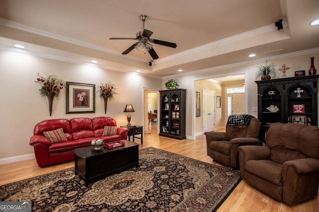 4149 Yancey Rd, Douglasville, GA 30135 - living room with a tray ceiling, crown molding, a ceiling fan, and wood finished floors