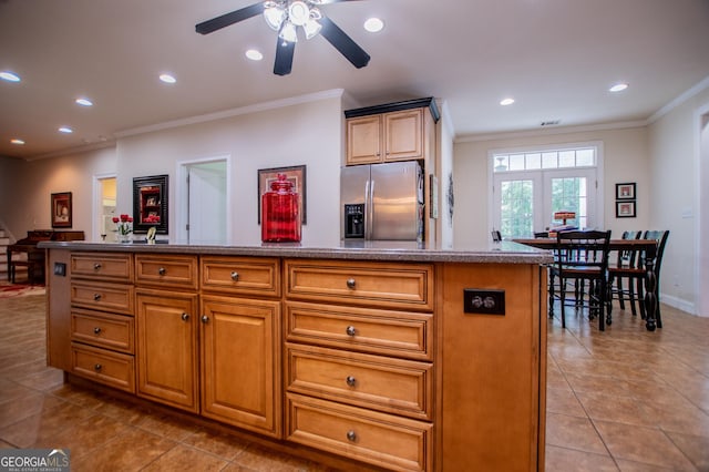 4149 Yancey Rd, Douglasville, GA 30135 - kitchen with stainless steel fridge, recessed lighting, crown molding, a kitchen island, and light tile patterned flooring