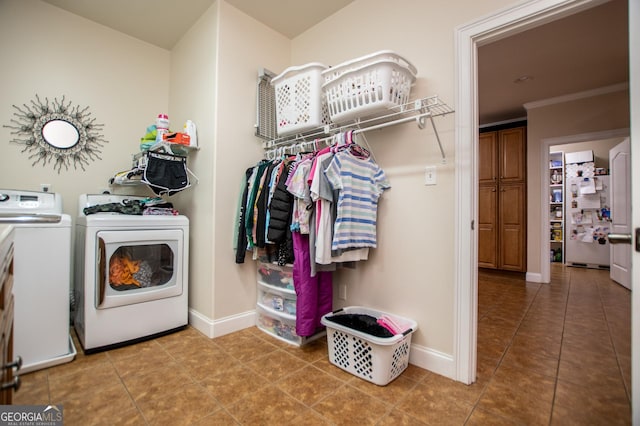 4149 Yancey Rd, Douglasville, GA 30135 - laundry area featuring washer and clothes dryer, tile patterned flooring, laundry area, and baseboards