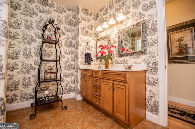 4149 Yancey Rd, Douglasville, GA 30135 - bathroom with wallpapered walls, tile patterned floors, baseboards, and double vanity