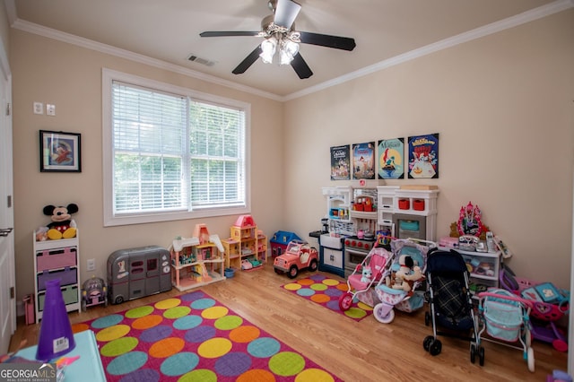 4149 Yancey Rd, Douglasville, GA 30135 - playroom featuring visible vents, ornamental molding, a ceiling fan, and wood finished floors