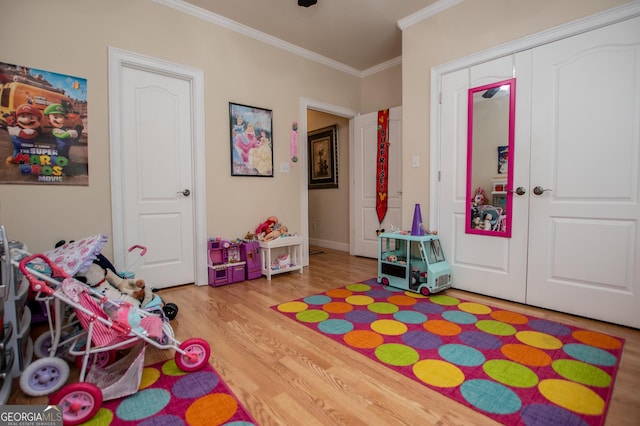 4149 Yancey Rd, Douglasville, GA 30135 - game room featuring baseboards, light wood-type flooring, and crown molding