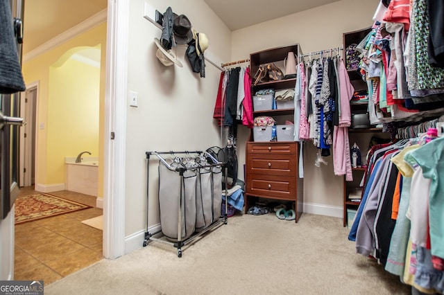 4149 Yancey Rd, Douglasville, GA 30135 - walk in closet with carpet floors, tile patterned floors, and arched walkways