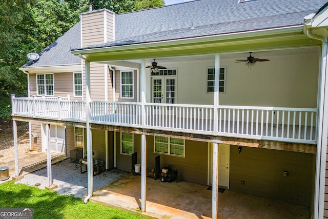 4149 Yancey Rd, Douglasville, GA 30135 - back of property featuring a garage, a patio area, roof with shingles, and ceiling fan