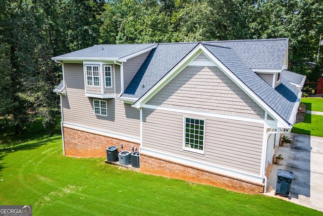 4149 Yancey Rd, Douglasville, GA 30135 - back of property with brick siding, a shingled roof, cooling unit, and a lawn