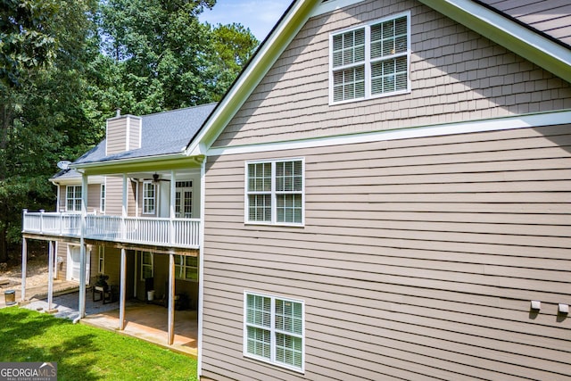 4149 Yancey Rd, Douglasville, GA 30135 - rear view of property with a deck, a patio, a lawn, and a chimney