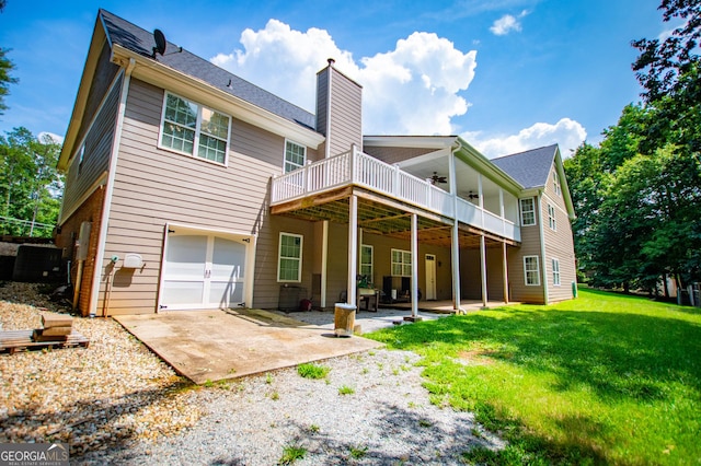 4149 Yancey Rd, Douglasville, GA 30135 - rear view of property featuring a yard, an attached garage, a ceiling fan, a chimney, and a patio
