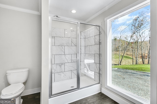 350 Pea Ridge Rd, Ball Ground, GA 30107 - bathroom featuring crown molding, a shower stall, toilet, baseboards, and wood finished floors